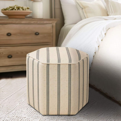 Martha Stewart Ellen Accent Ottoman in a bedroom setting with a bed and dresser in the background.