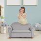 Girl Standing behind Qaba Ergonomic Foam Kids Sofa with Inner Toy Storage Chest Gray