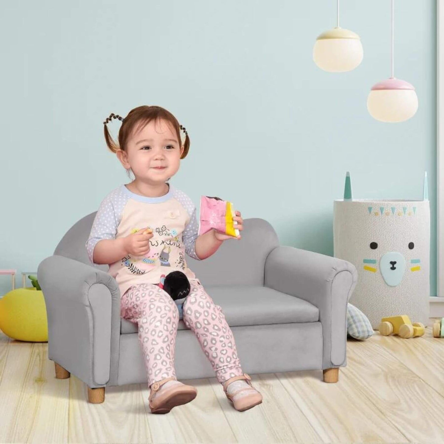 Girl Sitting on Qaba Ergonomic Foam Kids Sofa with Inner Toy Storage Chest Gray