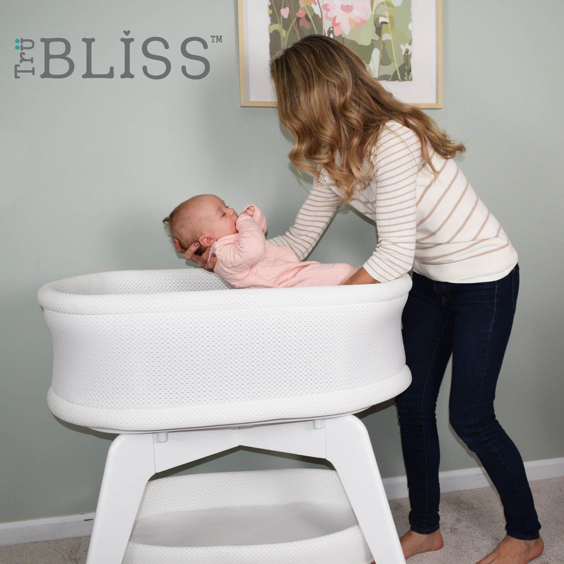 Mom Putting Baby in TruBliss Evi Smart Bassinet - White on White