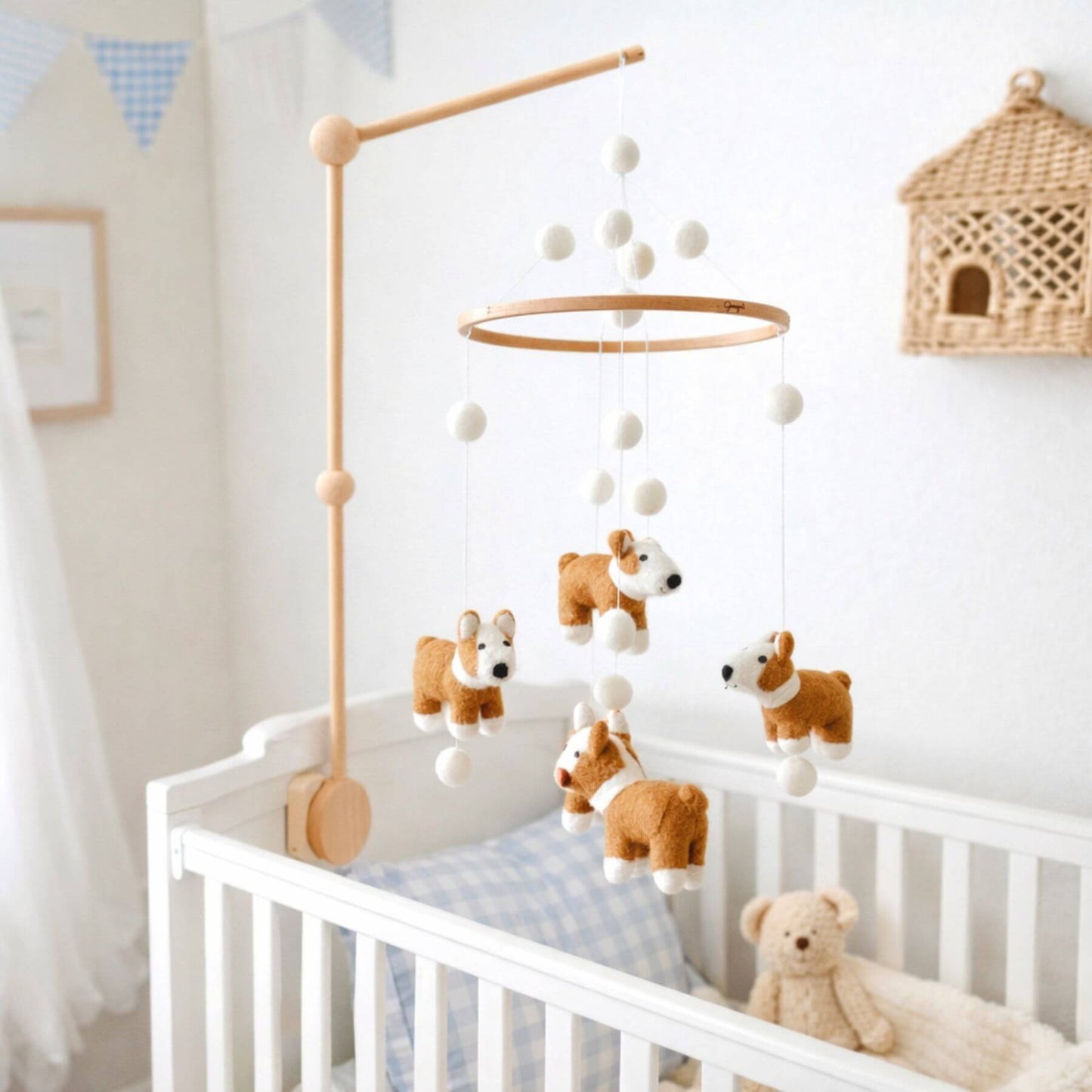 Nursery with a crib and Ganapati Crafts Co. Felt Corgi Dog Baby Mobile in a bright room.