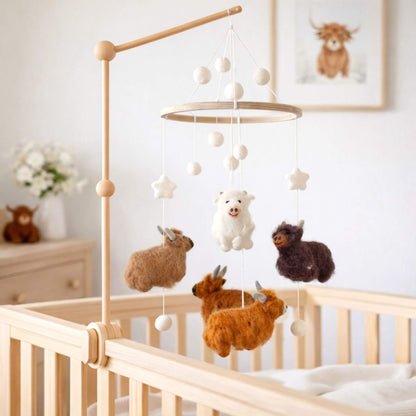 Ganapati Crafts Co. Felt Baby Mobile - Highland Cow in a nursery setting