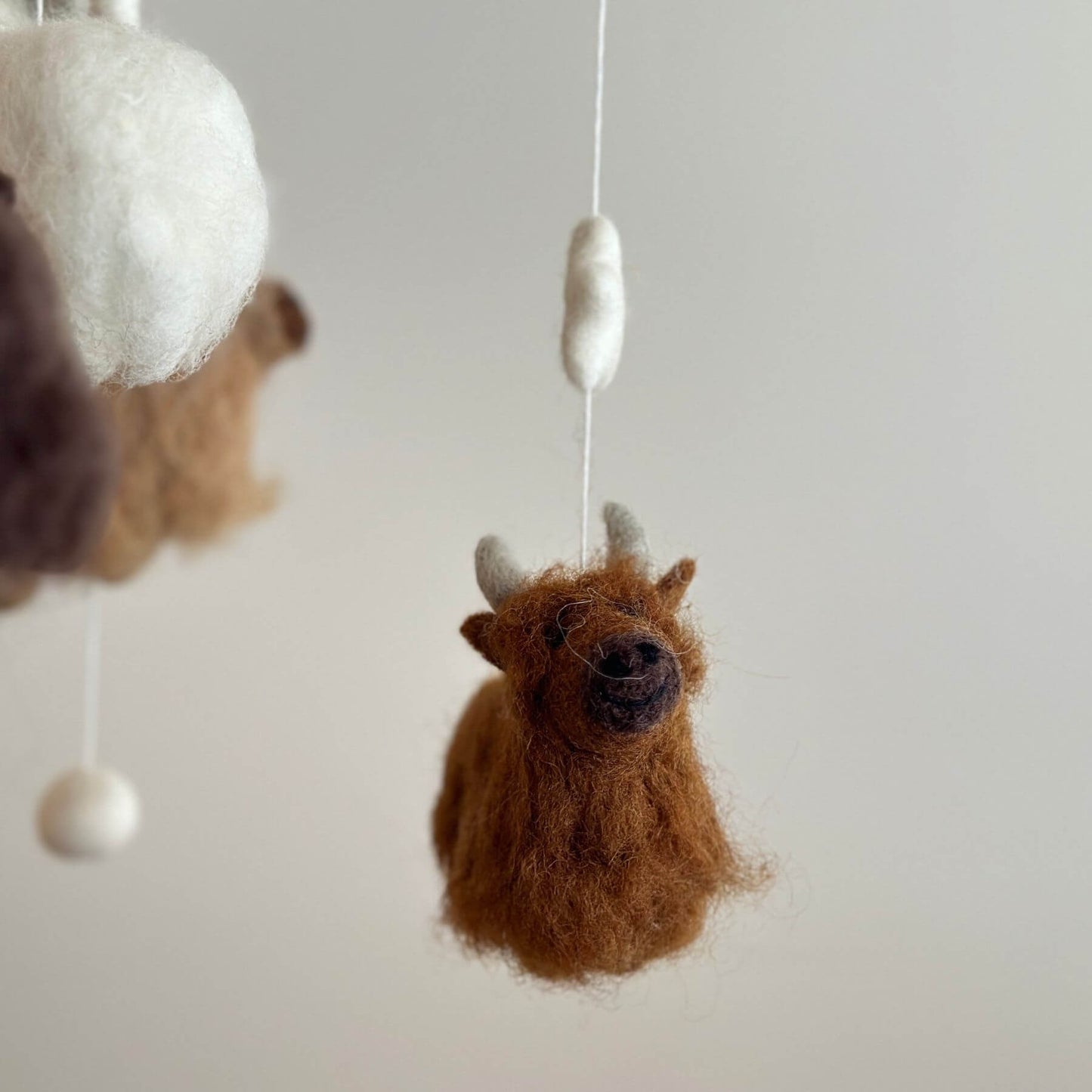 Close-up of Ganapati Crafts Co. Felt Baby Mobile - Highland Cow