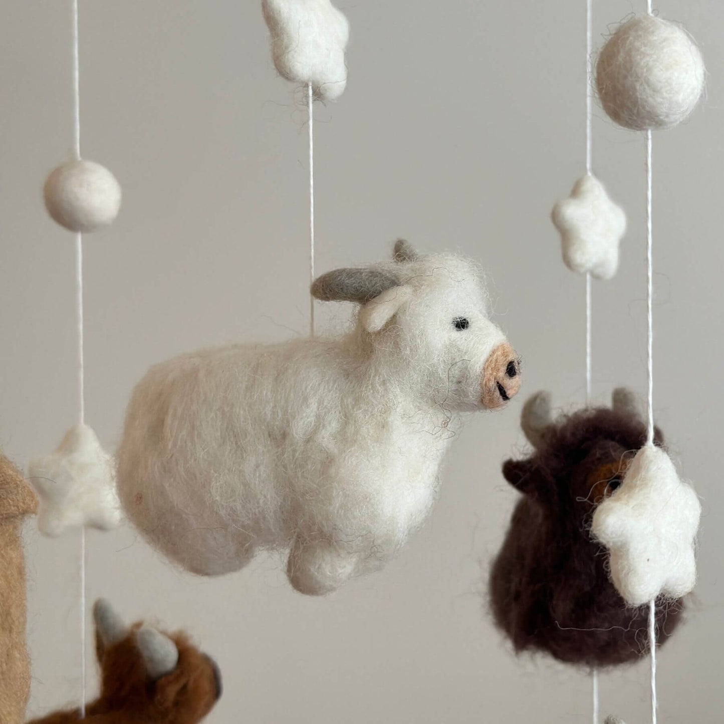 Close-up of Ganapati Crafts Co. Felt Baby Mobile - Highland Cow