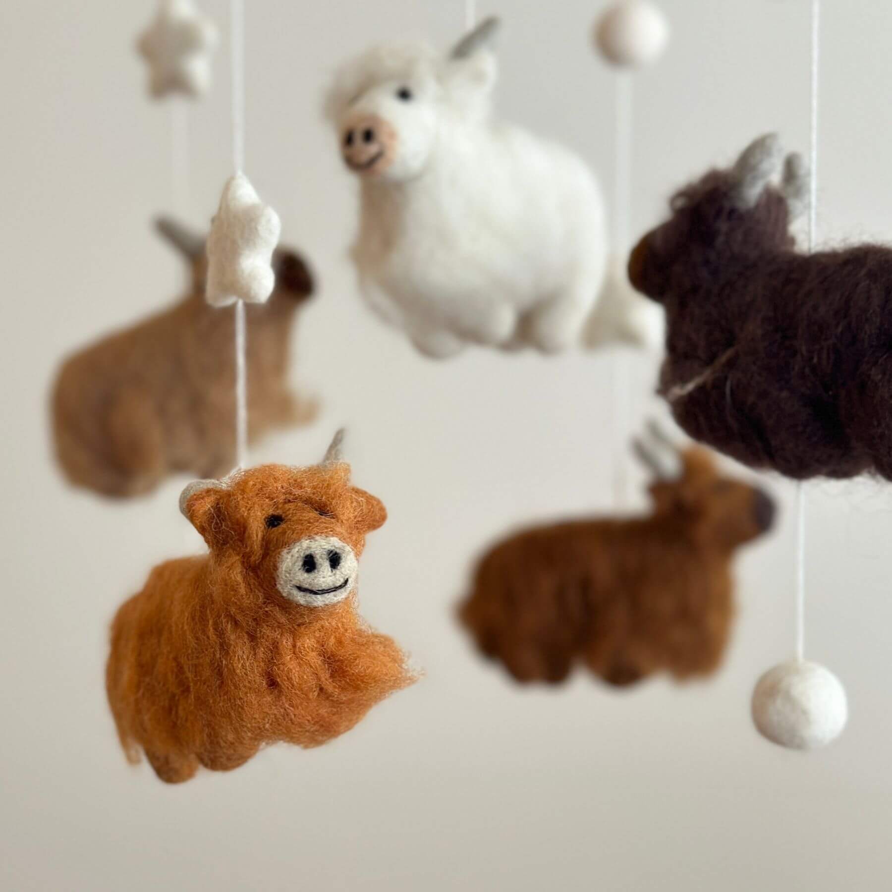 Close-up of Ganapati Crafts Co. Felt Baby Mobile - Highland Cow