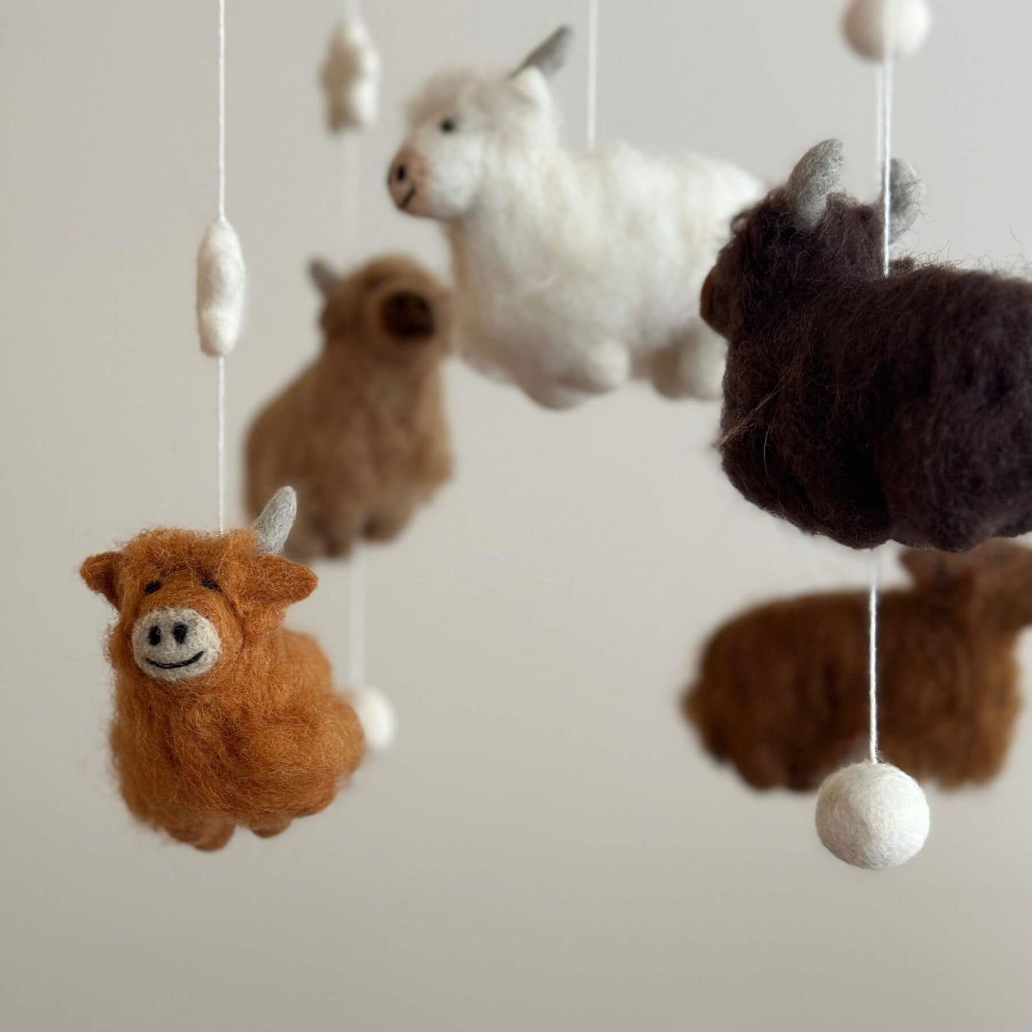 Close-up of Ganapati Crafts Co. Felt Baby Mobile - Highland Cow