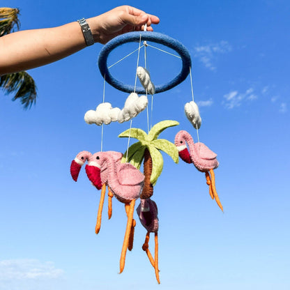 Ganapati Crafts Co. Flamingo Baby Mobile against a clear blue sky