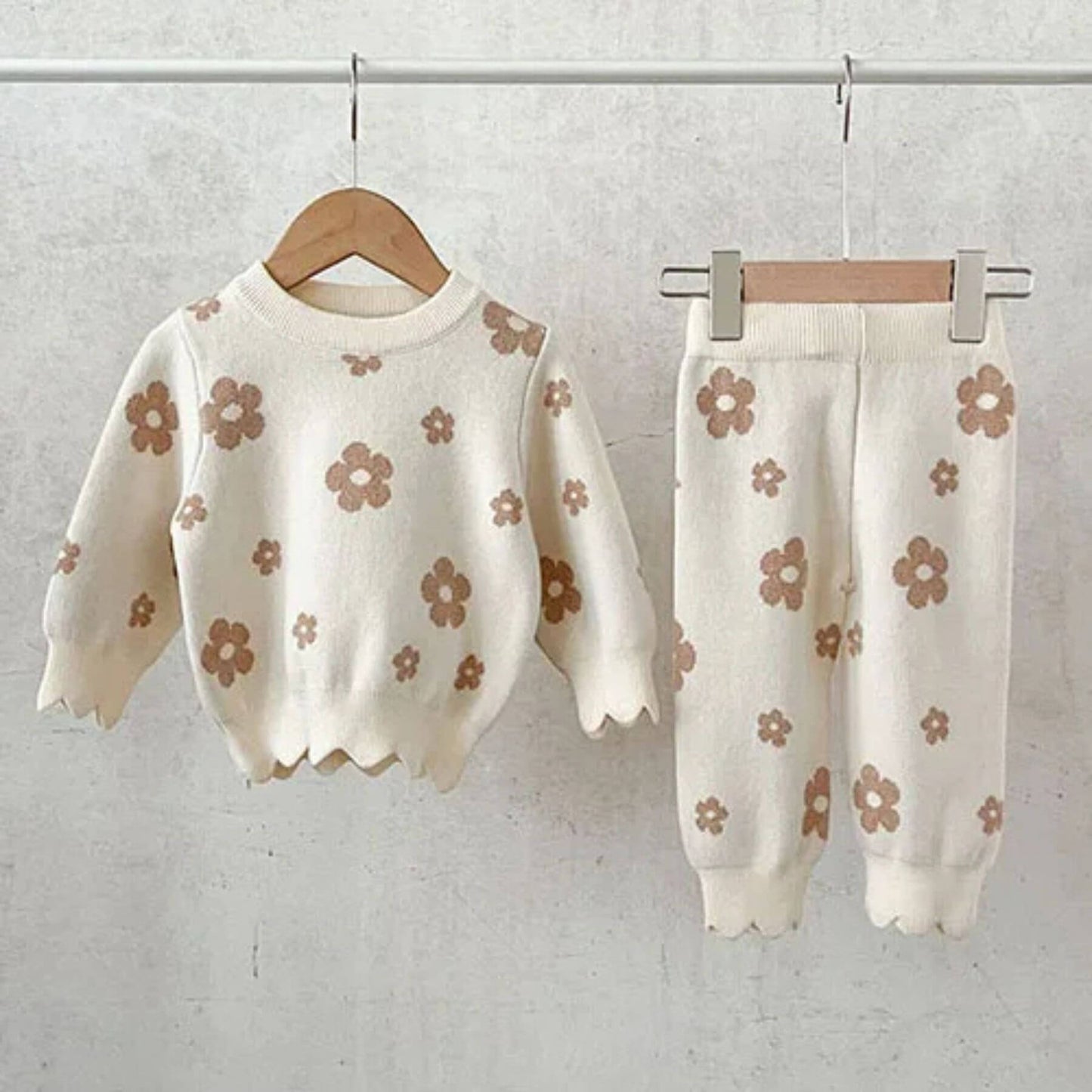 Flower Power Knitted Set with floral pattern on hangers against a light background