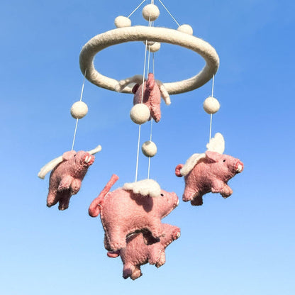 Ganapati Crafts Co. Felt Baby Mobile - Flying Pig against a clear blue sky