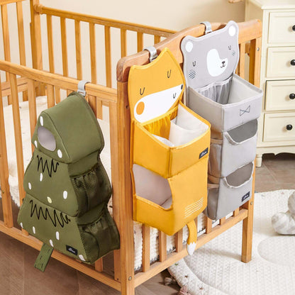Forest Friends Hanging Organizers hanging on a wooden crib in a nursery.