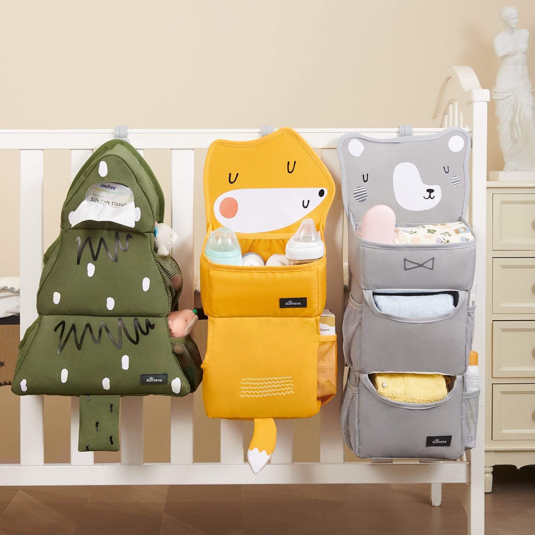 Three Forest Friends Hanging Organizers hanging on a crib.