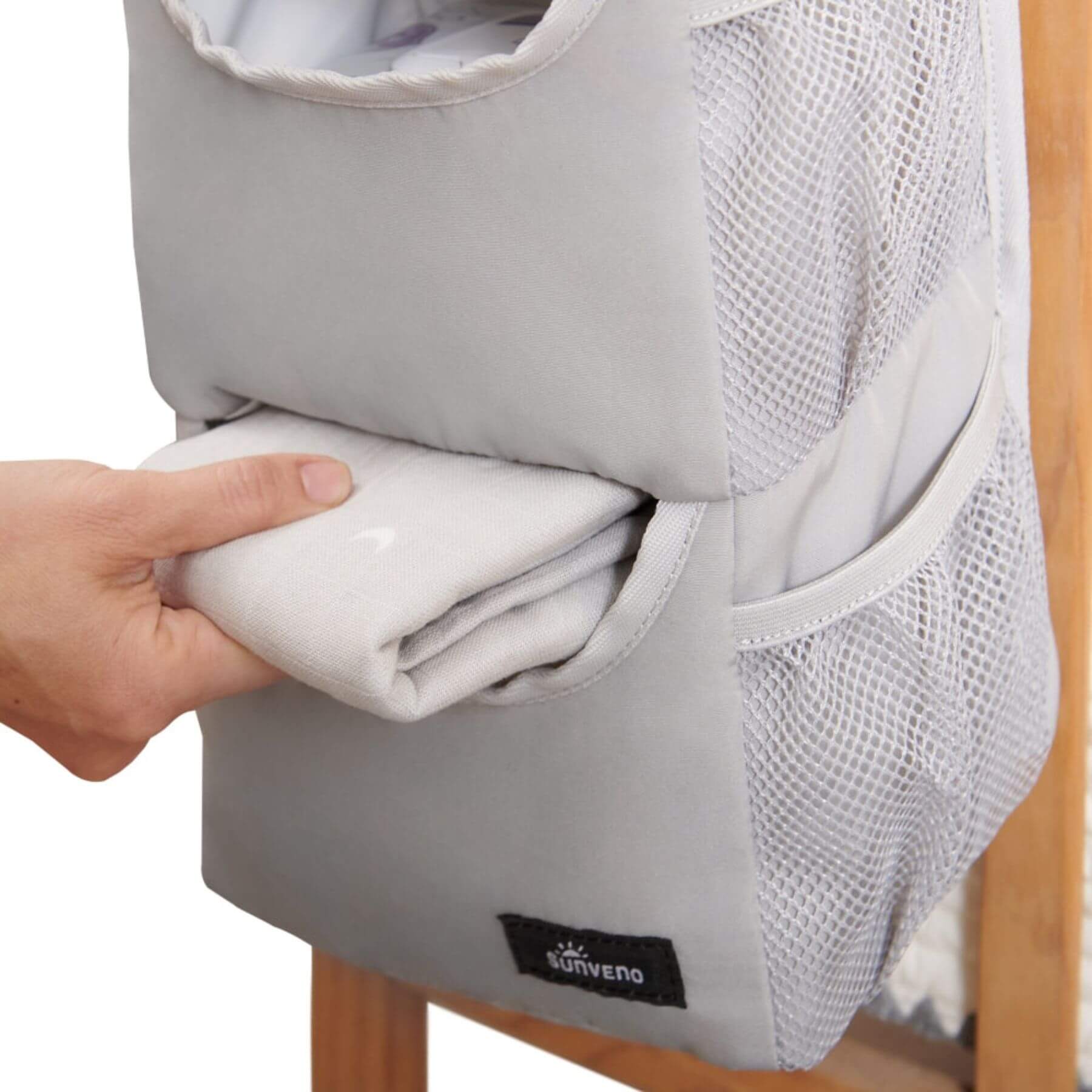Forest Friends Hanging Organizer bear with a hand pulling out a white garment, Suvelo brand visible.
