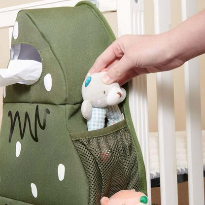 Forest Friends Hanging Organizer Tree with a hand holding a plush toy, hanging on a crib
