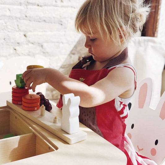 Child playing with educational toys at a table