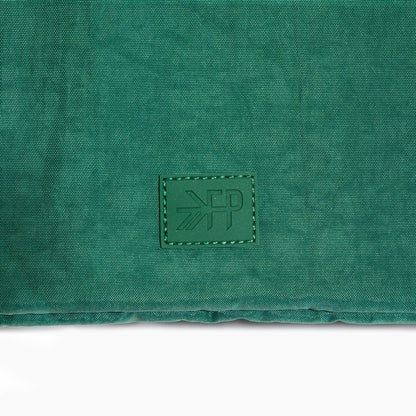 Green fabric surface with a brand logo in the center