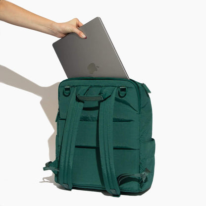 Forest Zurich Diaper Bag with a laptop being placed into it on a white background