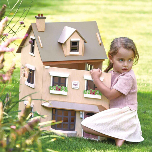 Young girl holding Tender Leaf Foxtail Villa in a grassy outdoor setting