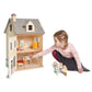 Child playing with Tender Leaf Foxtail Villa and dolls on a white background