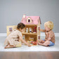 Two children playing with Tender Leaf Foxtail Villa Pink on a plain background