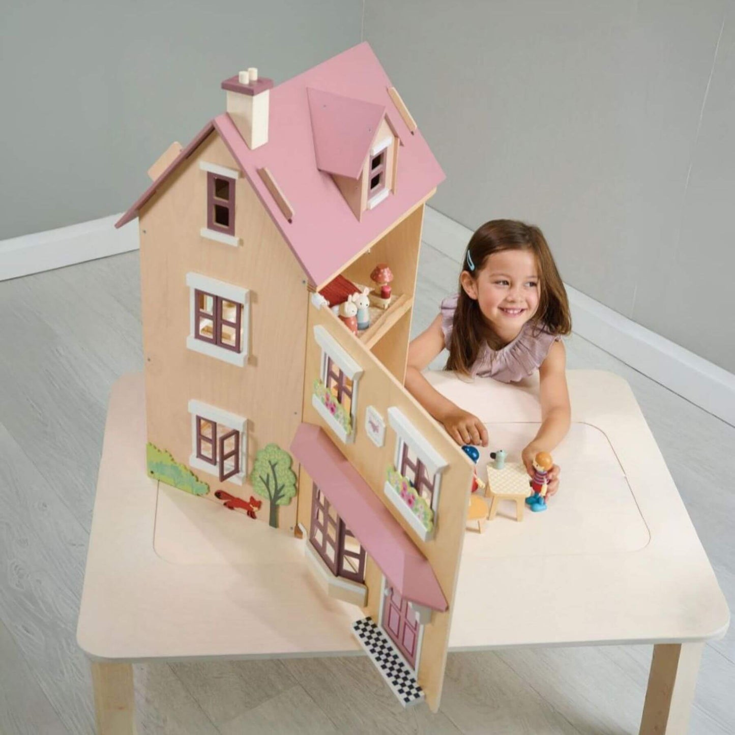 Child playing with Tender Leaf Foxtail Villa Pink on a table