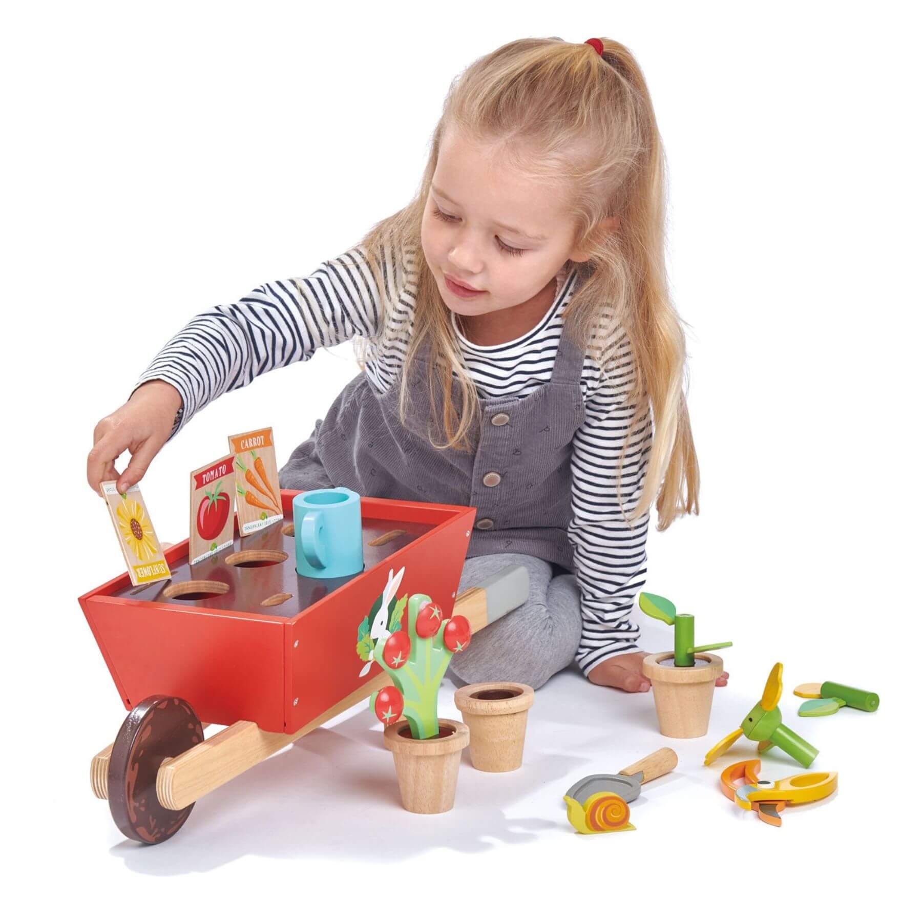 Child playing with Tender Leaf Garden Wheelbarrow Set