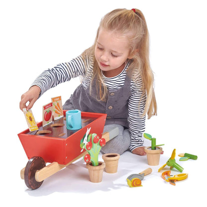 Child playing with Tender Leaf Garden Wheelbarrow Set