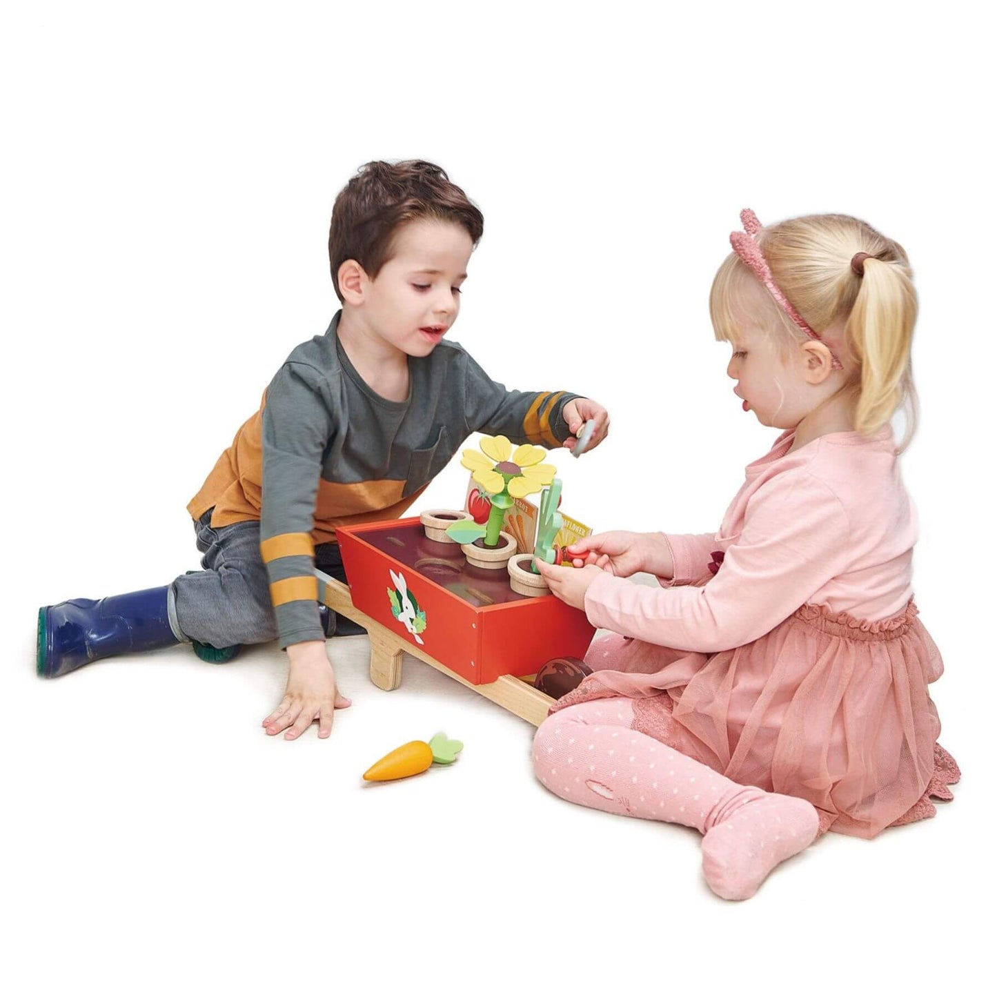 Two children playing with Tender Leaf Garden Wheelbarrow Set