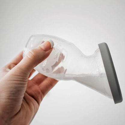 Hand holding Haakaa Gen 1 Silicone Pump with Silicon Lid 1 Set