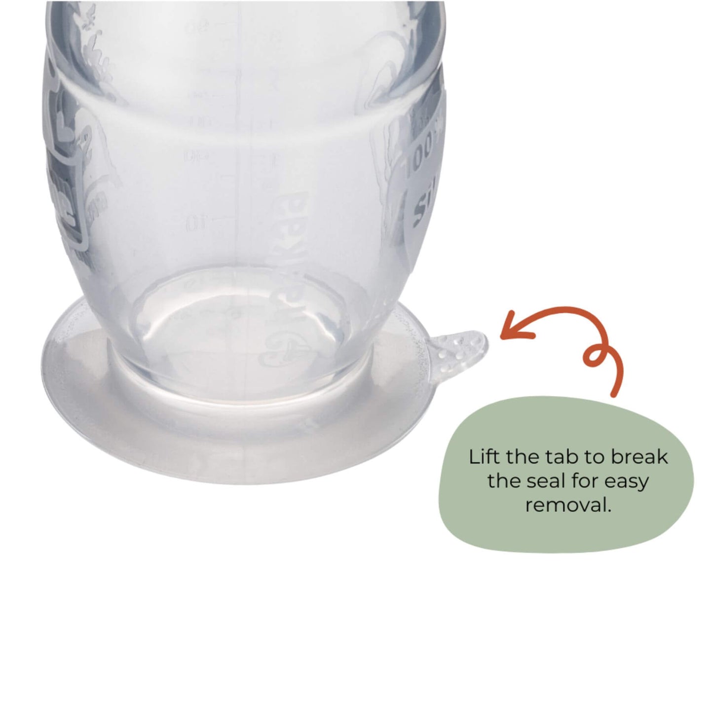 A close-up of Haakaa Generation 2 Silicone Breast Pump, shown on a white background with an orange arrow and a green text bubble that reads, 'Lift the tab to break the seal for easy removal.'.