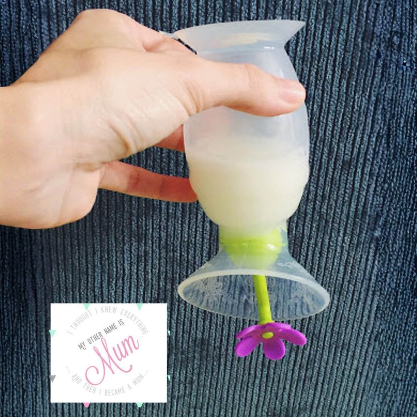 Haakaa Gen 1 Silicone Breast Pump 4 oz and Silicone Flower Stopper Set held by a hand on a textured blue background