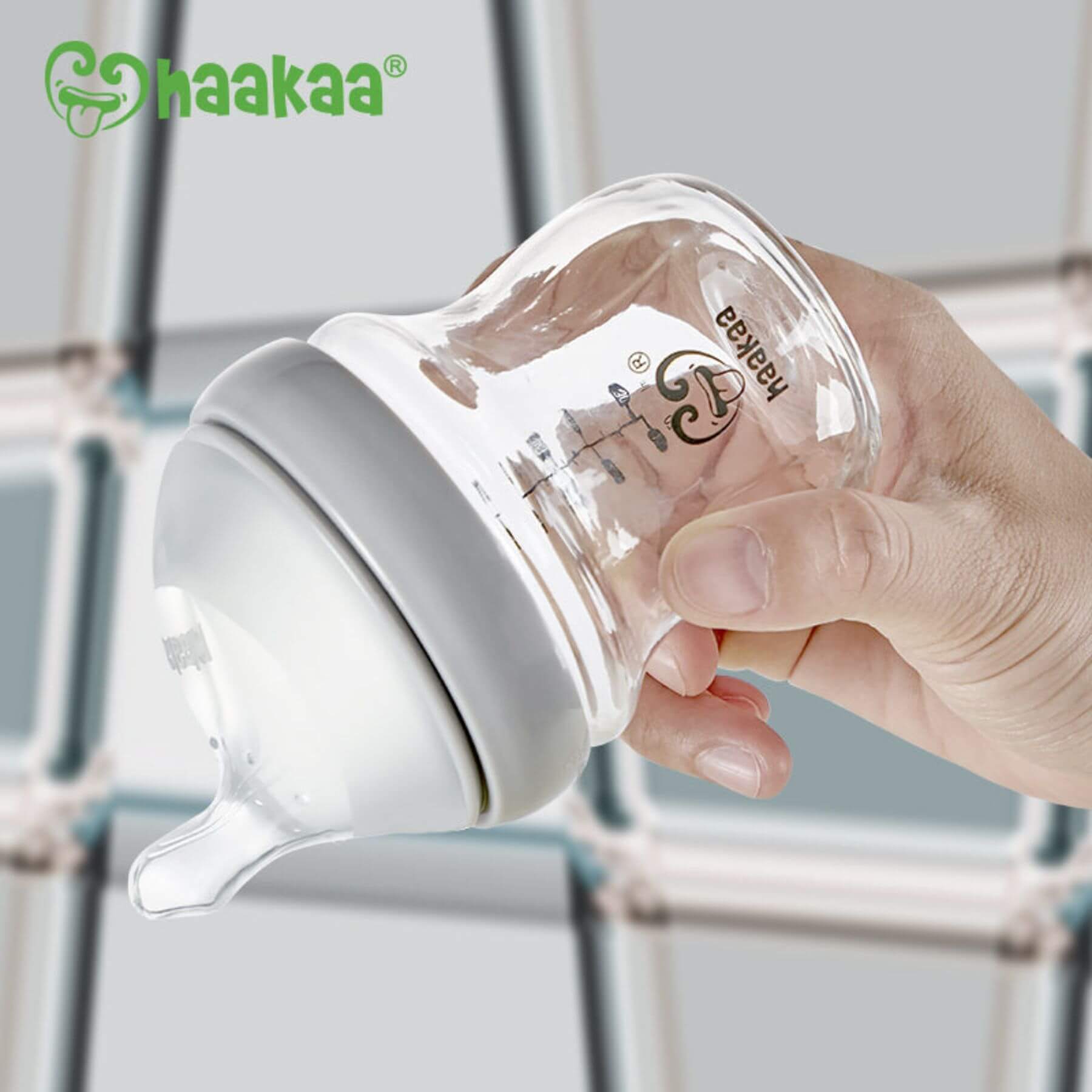 Hand holding Haakaa Generation 3 Glass Baby Bottle Grey