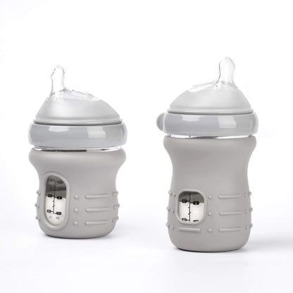 Two gray baby bottles with silicone covers