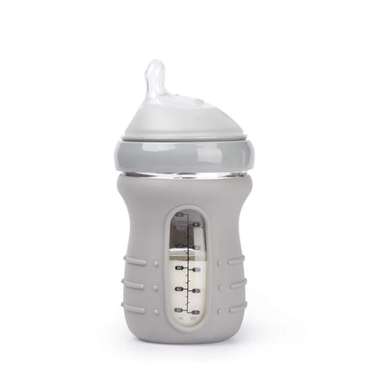 A baby bottle with a light gray silicone cover