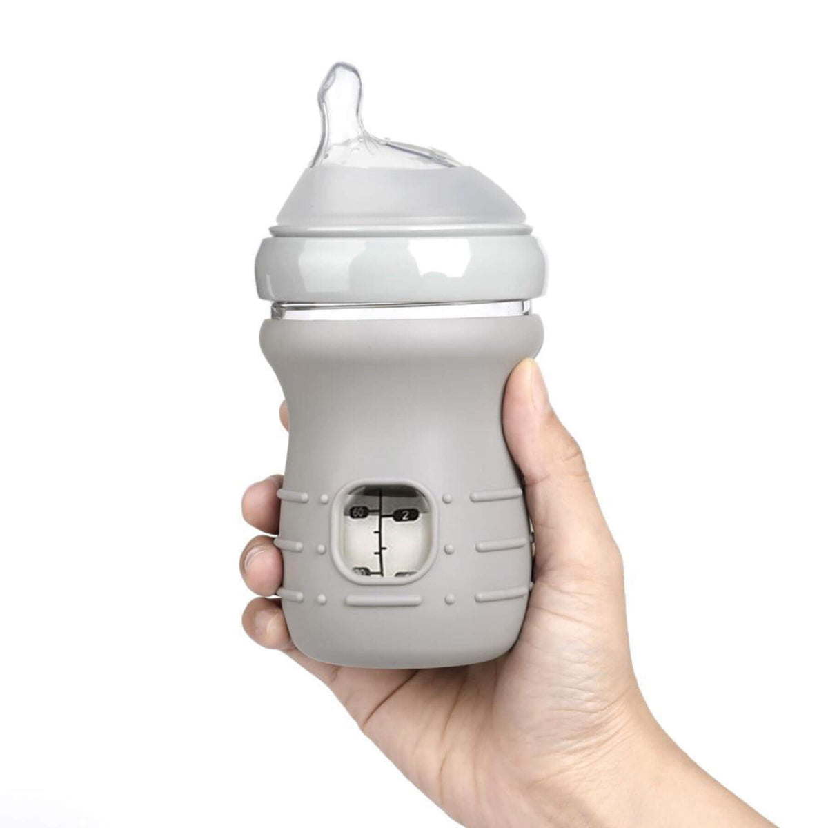 Hand holding a gray baby bottle with silicone cover