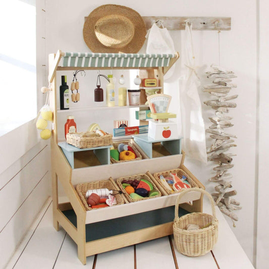 Tender Leaf General Stores with toys and accessories on a white floor.