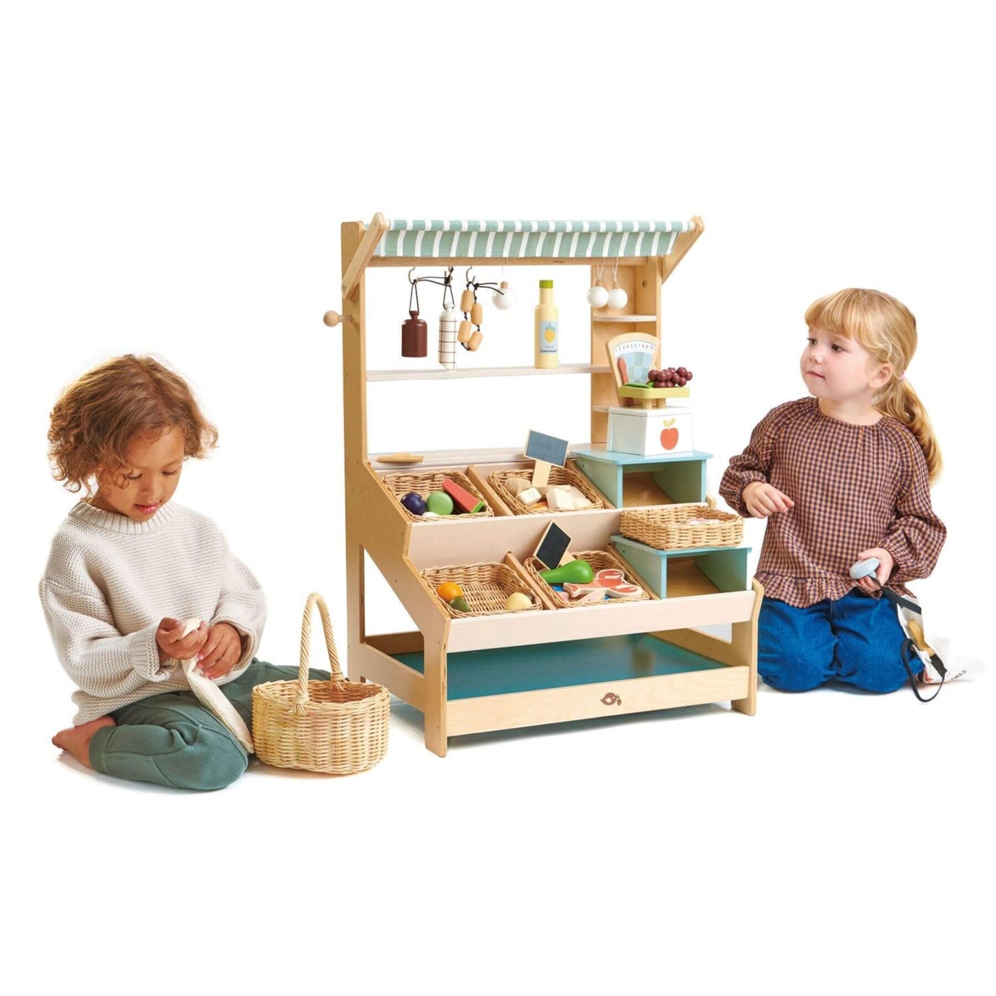 Two children playing with Tender Leaf General Stores on a white background
