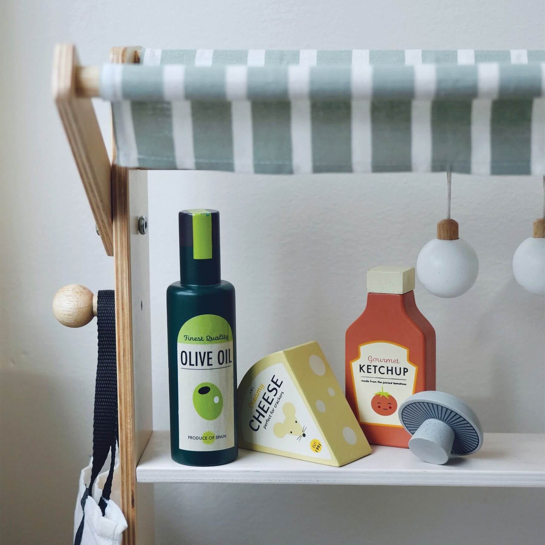 Tender Leaf General Stores with olive oil, cheese, and ketchup bottles on a shelf.