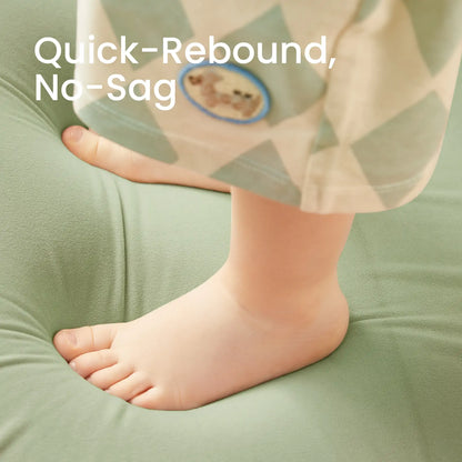 Baby foot on Tiny Land® GentleSnug Kid Chair Sage with text 'Quick-Rebound, No-Sag' in the background.