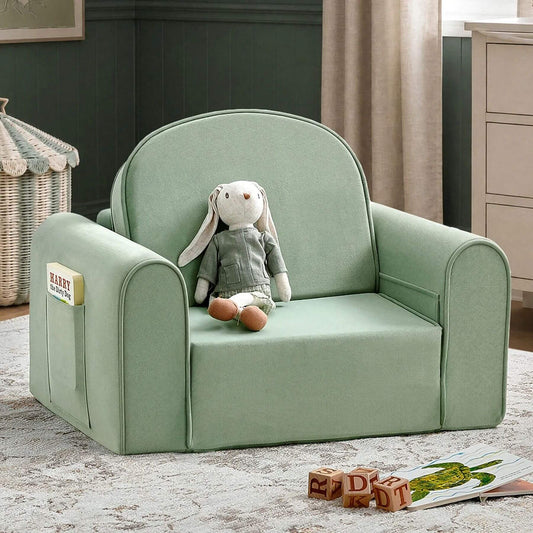 Tiny Land® GentleSnug Kids Sofa Chair with a plush white bunny doll sitting on it, placed in a styled nursery or playroom setting with a rug, curtains, and toys visible.