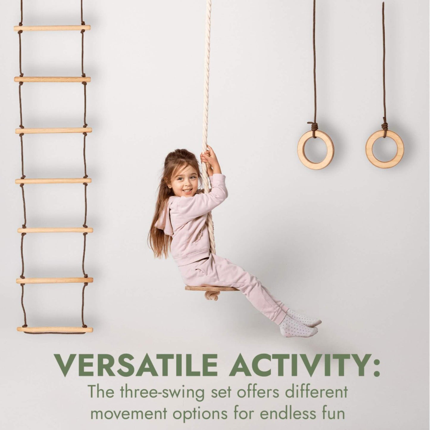 Child playing with a wooden swing set against a white background