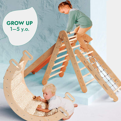 Goodevas 5in1 Montessori Climbing Set with a slide, climbing ladder, and curved padded bed, shown with two children in a bright indoor setting. A speech-bubble-style graphic reads 'GROW UP 1-5 y.