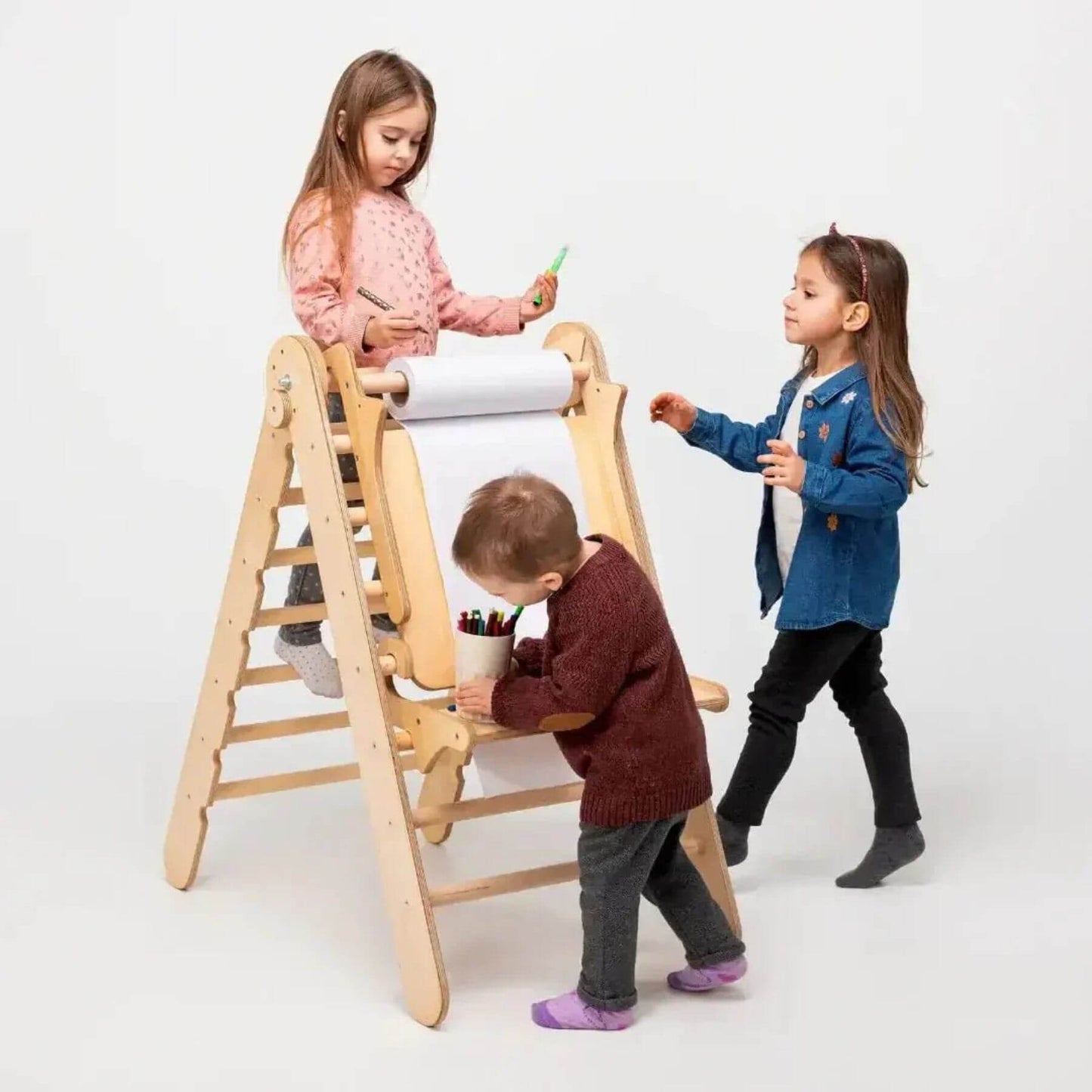 Children playing with a Goodevas wooden climbing with art addition