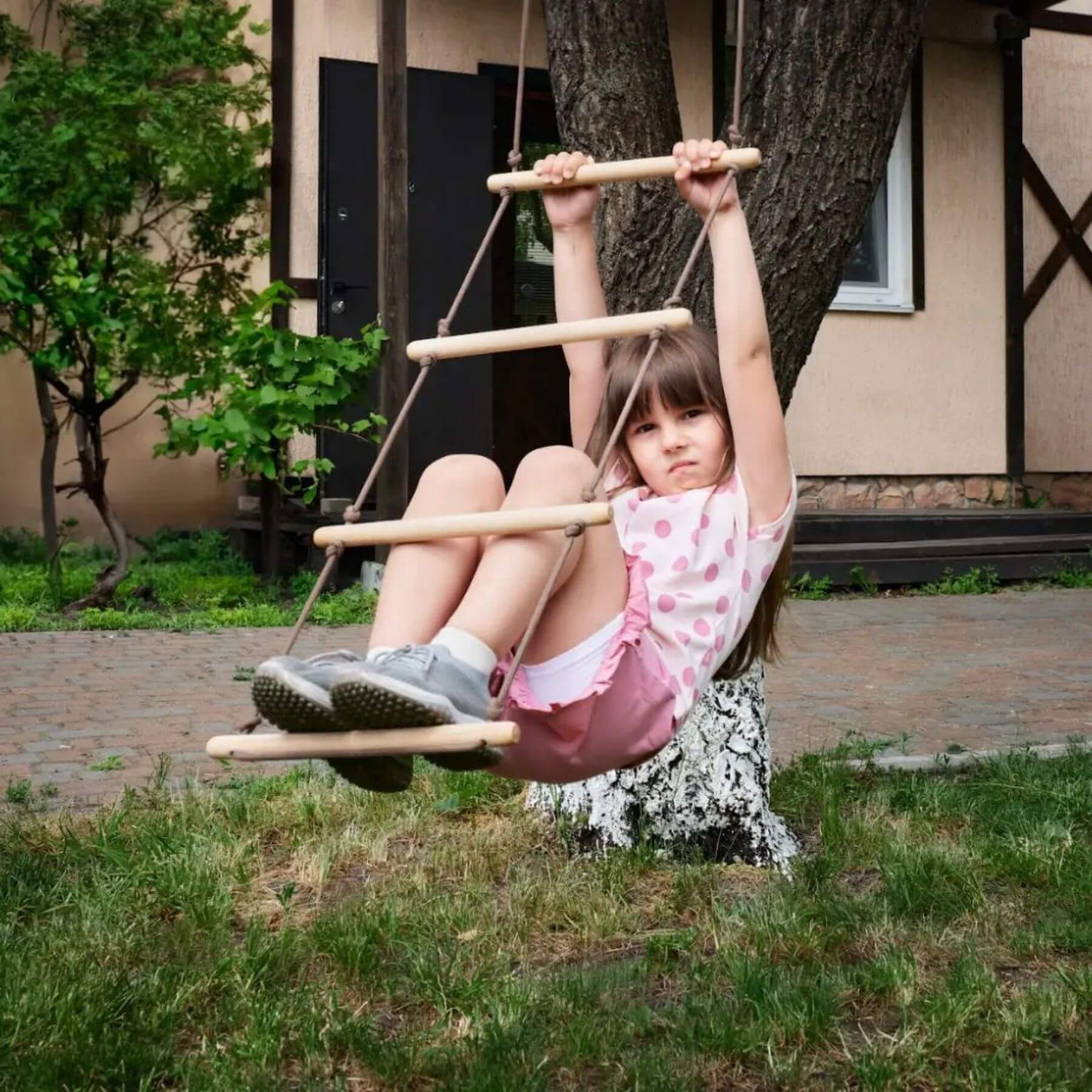 Child on Goodevas Climbing Rope Ladder in a backyard