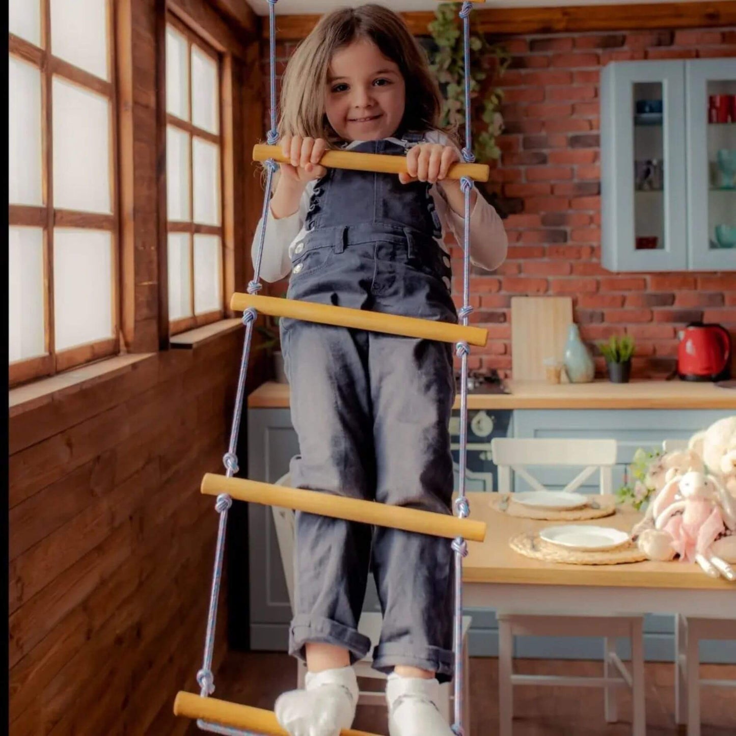 Child on Goodevas Climbing Rope Ladder in a dining room.
