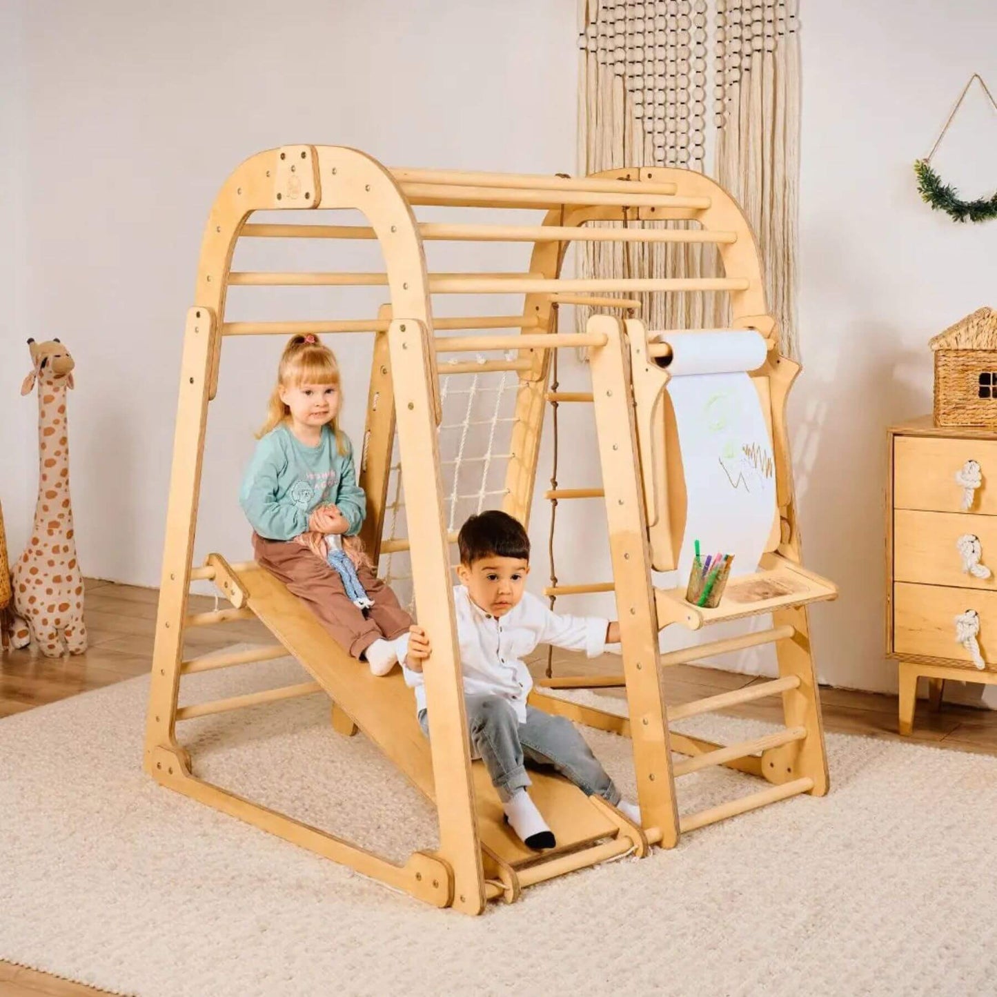 Children playing on Goodevas Indoor Pplayground in a room with toys and furniture.