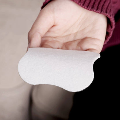 Hand holding Haakaa Soothing Hydrogel Breast Pad