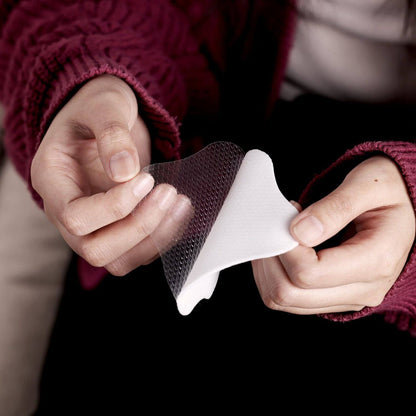 Close-up of hands holding a Haakaa Soothing Hydrogel Breast Pad