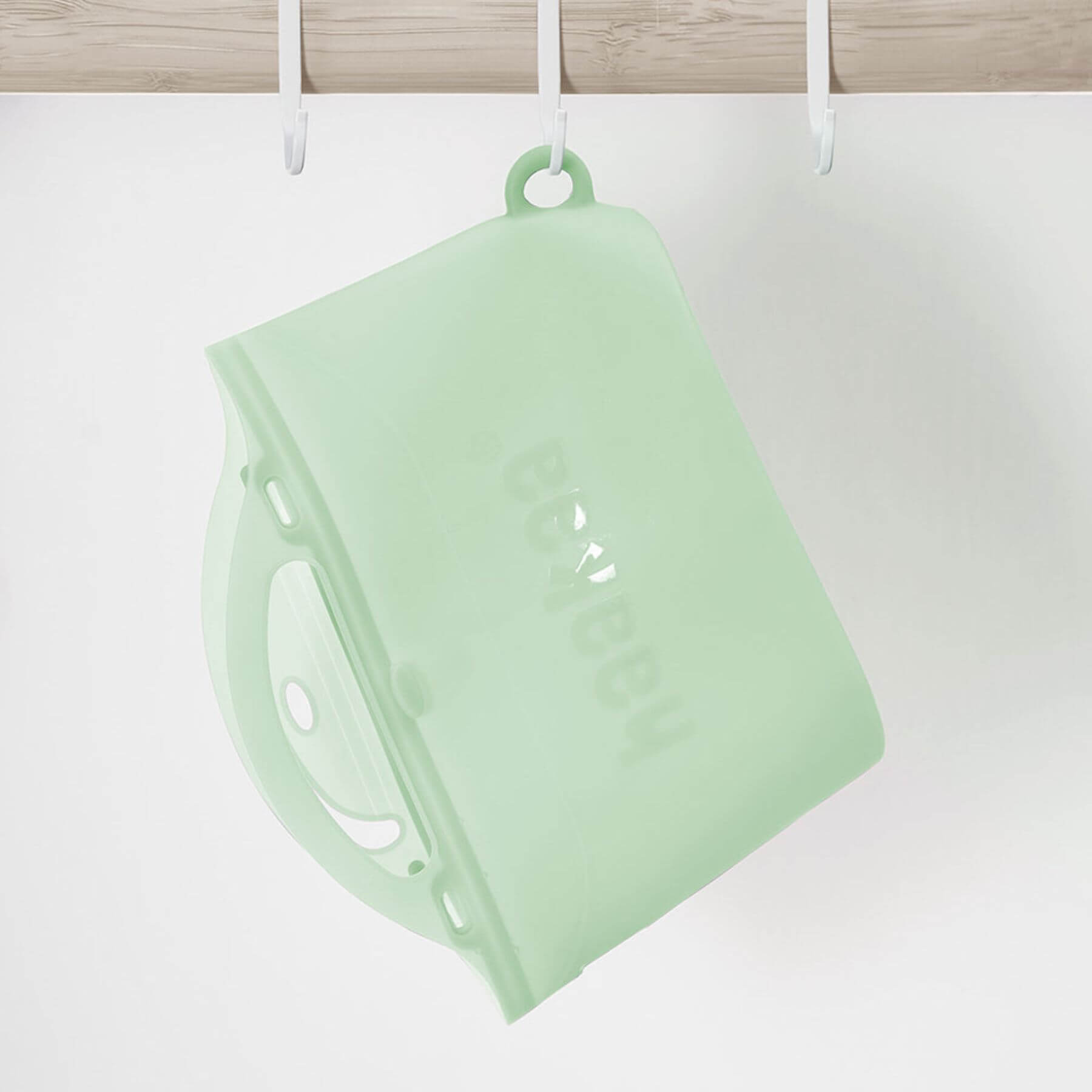 Haakaa Multipurpose Steamer & Steriliser Bag hanging on a hook