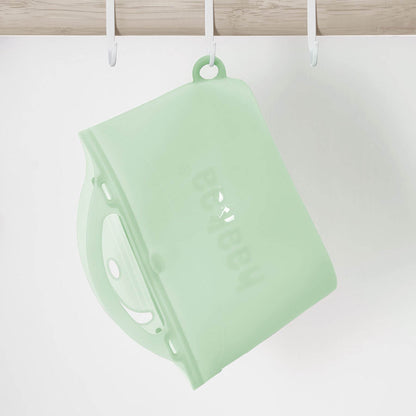 Haakaa Multipurpose Steamer & Steriliser Bag hanging on a hook