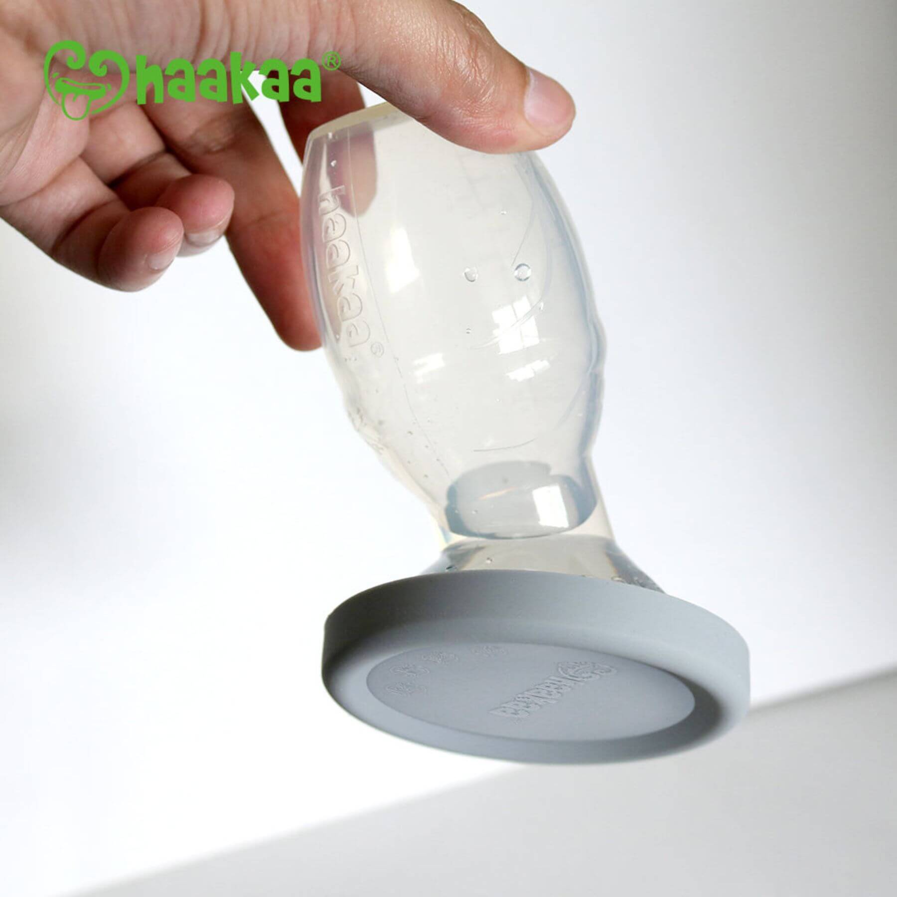 Hand holding Haakaa Silicone Breast Pump
